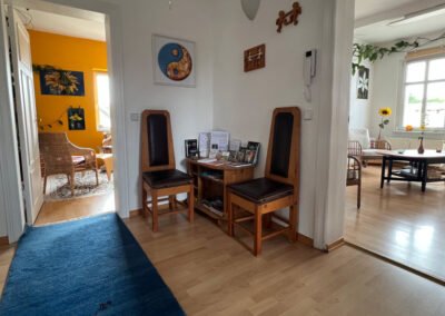 Empfangsbereich mit Sitzgelegenheiten und Blick in die Therapieräume der Heilpraxis Gall & Maier in Falkensee.